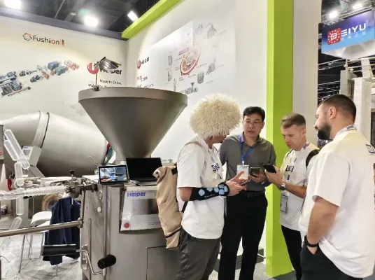 HELPER staff discussing processing equipment with visitors at Gulfood Manufacturing