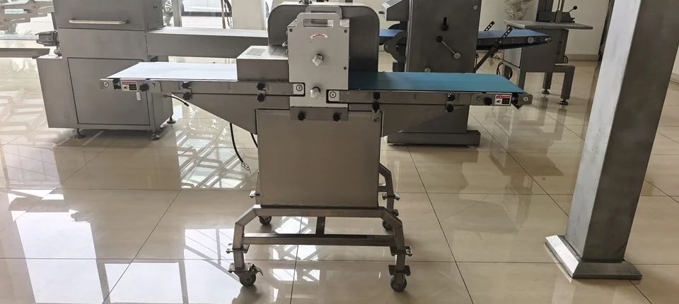 LC-500 side view showing the blue conveyors, cutting housing and wheeled base