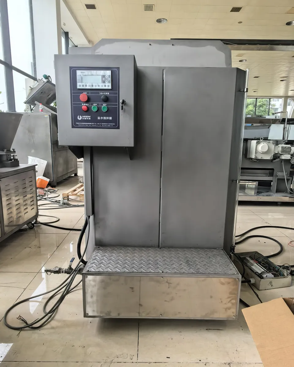 Front view of the HELPER saltwater mixing tank with control enclosure and access platform