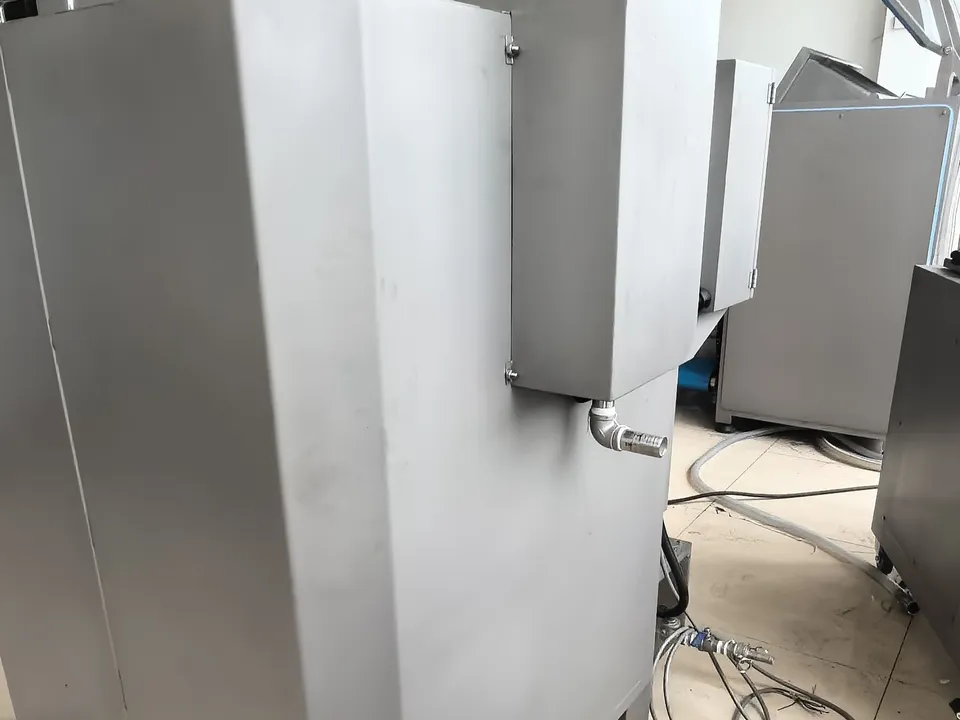 Side view of the saltwater mixing tank showing external pipe connections